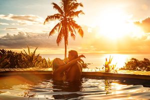 Couple-embracing-on-a-Caribbean-beach-at-sunset